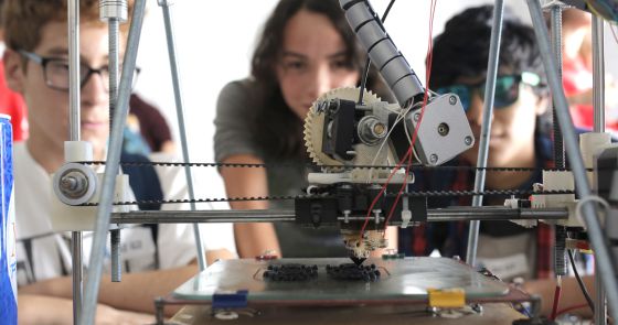Three students watching in awe as the magic happens